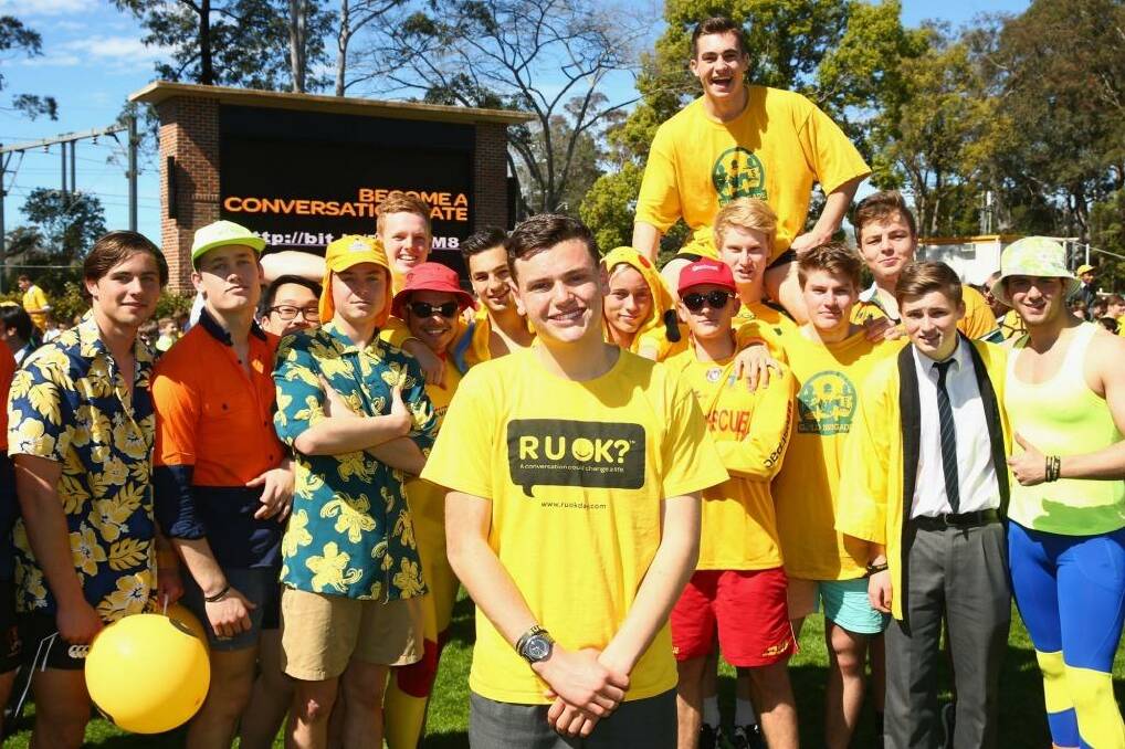 Cancer survivor Sam Clarke poses in front of fellow studenet during the Knox Yellow Assembly raising awareness for R U OK? Day at Knox Grammar in Wahroonga Photo: Mark Kolbe (Fairfax Media via Getty Images)