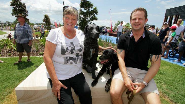 Charlene Simpson poses with real life and statue Sarbi, the Australian Special Forces explosives detection dog, and her son, handler Warrant Officer David Simpson. Photo: Michelle Smith