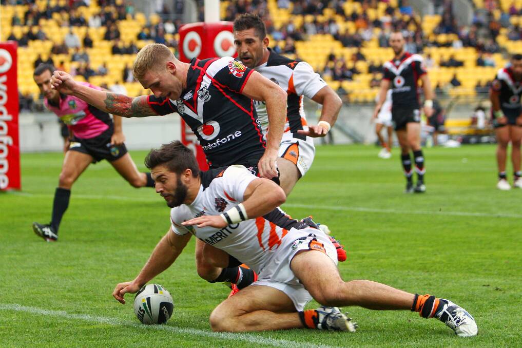 James Tedesco scores a try after beating the defence of Sam Tomkins during the round four NRL match between the New Zealand Warriors and Wests Tigers. Picture: Hagen Hopkins/Getty Images