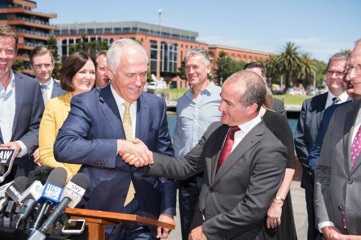 Prime Minister Malcolm Turnbull (centre left) shakes hands with Acting Victorian Premier James Merlino while speaking to the media during a visit to Geelong, Wednesday, January 17, 2018. The Geelong and Corangamite region is the first to get funding under the federal government's $220 million Regional Jobs and Investment pilot program. It's expected the $20 million cash injection will create 600 jobs during construction and 600 ongoing jobs once the projects are completed in the regional Victorian city. (AAP Image/Ellen Smith) NO ARCHIVING