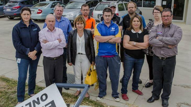 Some of the Hume business owners who are considering a class action against Telstra after they lost internet services for more than a week. They are outside a business vandalised when security cameras and systems connected through the internet failed. Photo: Jamila Toderas