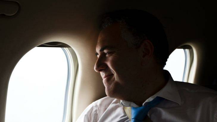 Treasurer Joe Hockey on board a private plane in 2013. Photo: Nic Walker
