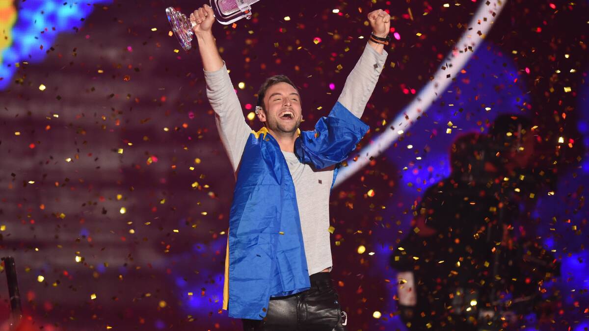 Mans Zelmerloew of Sweden reacts after winning on stage during the final of the Eurovision Song Contest 2015. (Photo by Nigel Treblin/Getty Images)