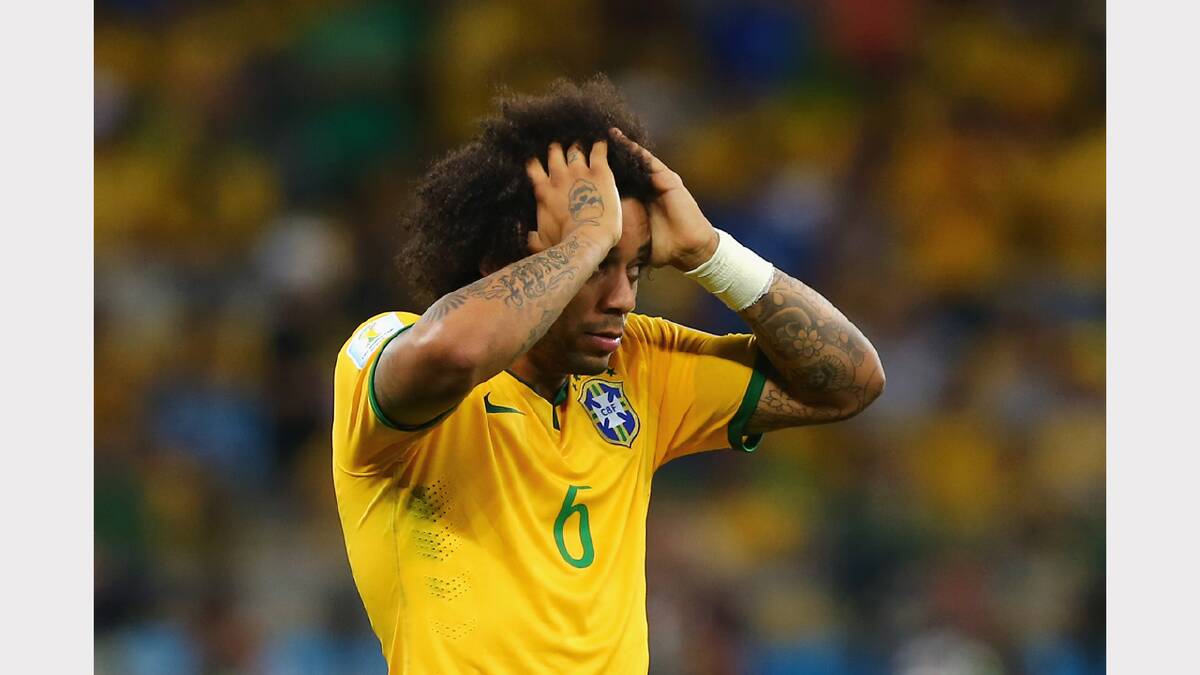  Marcelo of Brazil reacts after allowing a goal during the 2014 FIFA World Cup Brazil Semi Final match between Brazil and Germany at Estadio Mineirao on July 8, 2014 in Belo Horizonte, Brazil.  (Photo by Martin Rose/Getty Images)	