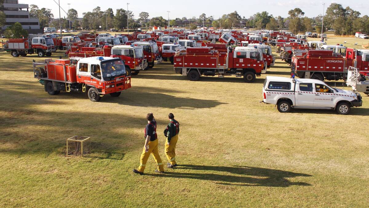 Fire vehicles gather at a staging ground in Penrith ahead of deployment to fires in the Blue Mountains. Photo: ANDREW MEARES