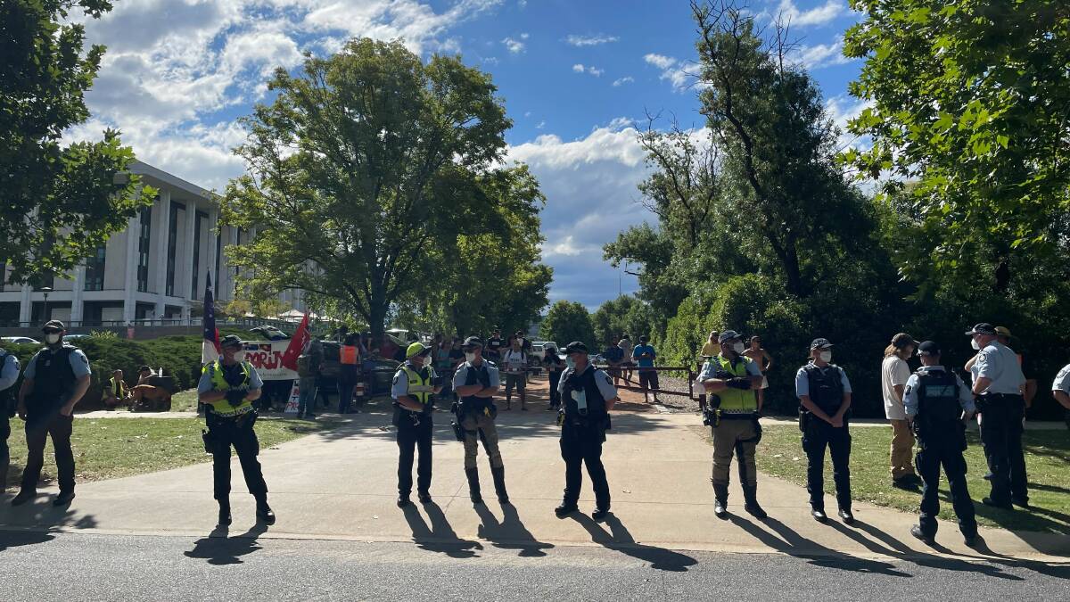 A line of police blocked the entrance to the Patrick White Lawns at the National Library on Thursday afternoon. Picture: Sarah Basford Canales
