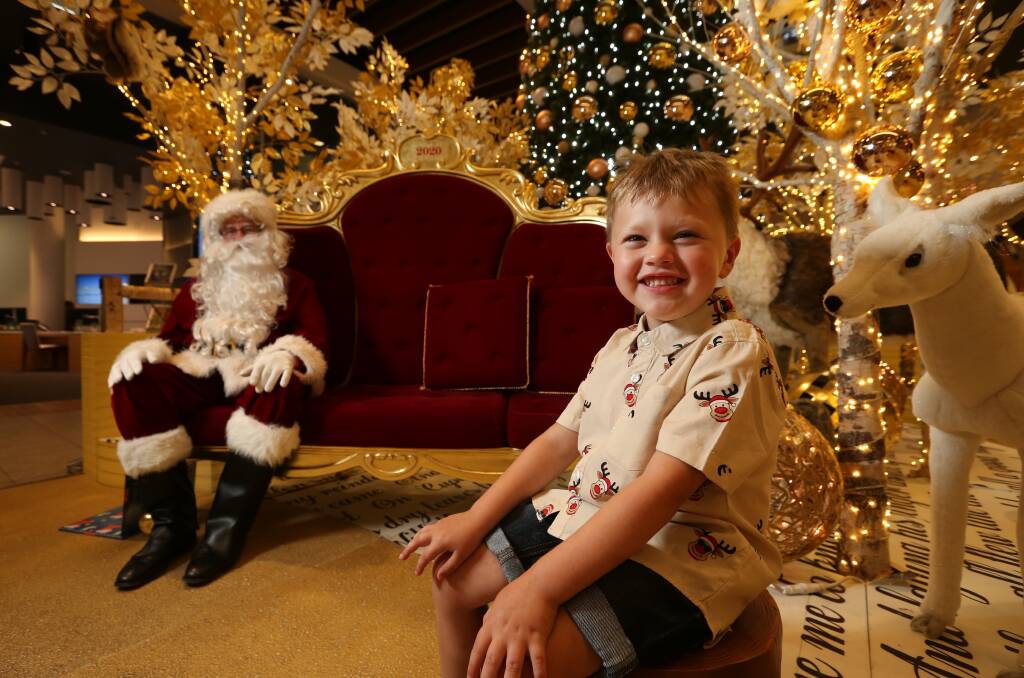 On the nice list: Four-year-old Nicholas Lambie of East Maitland, posing with Santa for his annual Christmas pic at Stockland Green Hills. Picture: Simone De Peak 