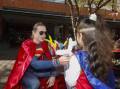 Superman making balloons for kids at Hero For Heartkids day at Macarthur Square. Picture: Simon Bennett.