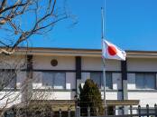 The Japanese flag flies at half-mast at the Japanese embassy on Saturday following the fatal shooting of former Japanese prime minister Shinzo Abe. Picture: Sitthixay Ditthavong