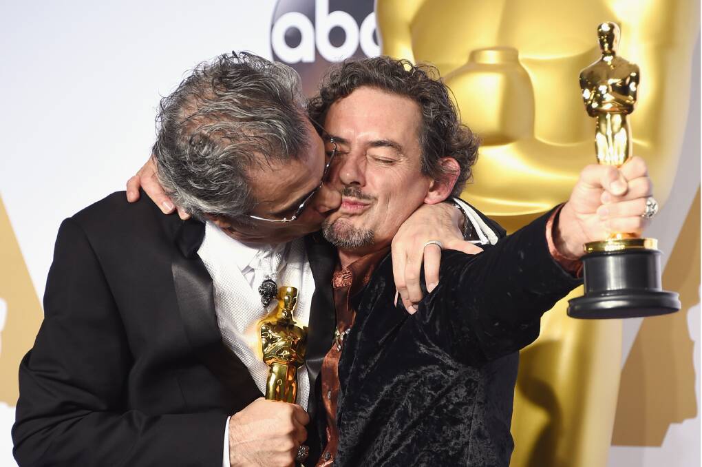 Exhilarated: David White, which a smoochy Mark Mangini, in the press room after winning his Oscar on Monday. Picture: Jason Merritt, Getty Images