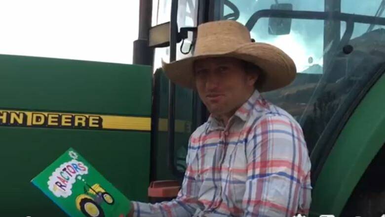 Croppa Creek farmer Ken Barnett reads Tractors by Catherine Foreman to kids as part of the Warialda Public School social media reading program. 