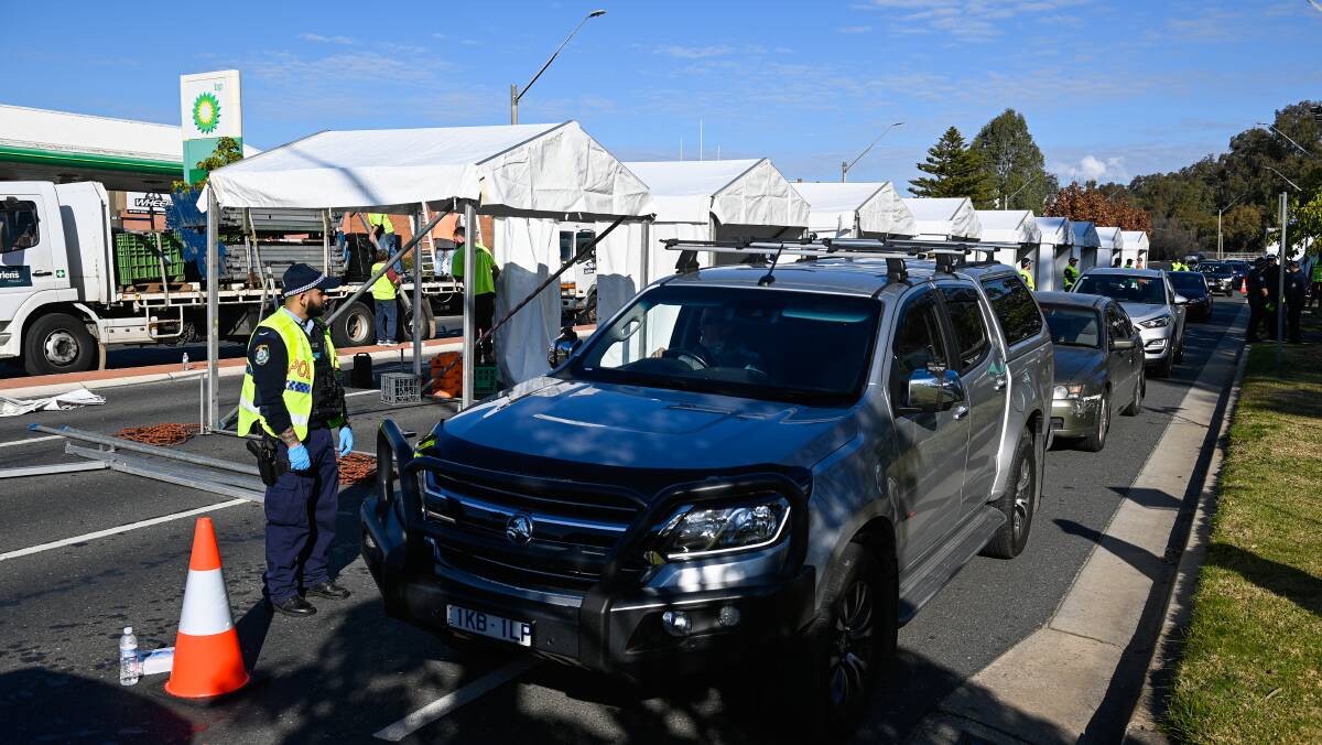 In a line-up: Cars proceed through Albury's Wodonga Place check-up on Thursday afternoon. Picture: MARK JESSER