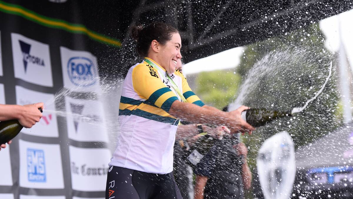 PARTY TIME: Chloe Hosking pops open a bottle on the podium after being crowned national elite women's criterium champion. Picture: Adam Trafford.