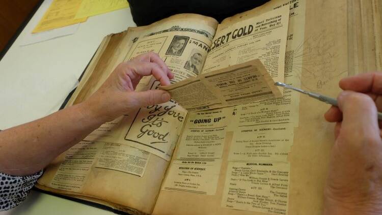 Preparing a scrapbook of theatre memorabilia for digitisation. Picture: National Library of Australia