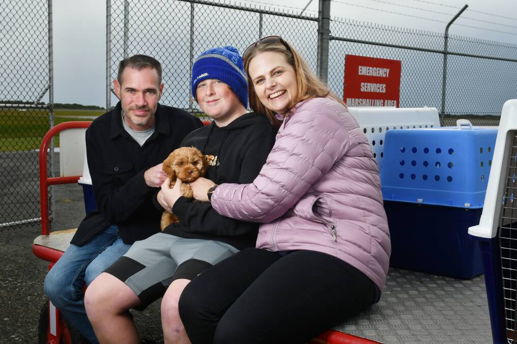 HAPPY ENDING: Devonport's Leigh Murray, Oliver and Lisa Fittkau had tears in their eyes when they finally met Enza the cavoodle on Saturday. Picture: Brodie Weeding