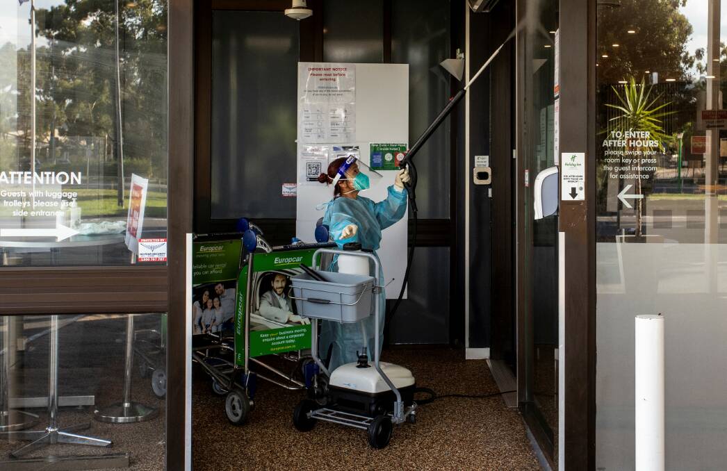 A cleaner during the disinfection of the Holiday Inn hotel in Melbourne, where the latest coronavirus outbreak came out of. Picture: Getty Images