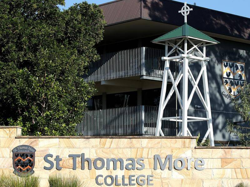 Two students at Brisbane's St Thomas More College have tested positive while in home quarantine.