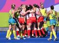 Australia's players regroup as England celebrate Holly Hunt's opening goal in the final. (Darren England/AAP PHOTOS)