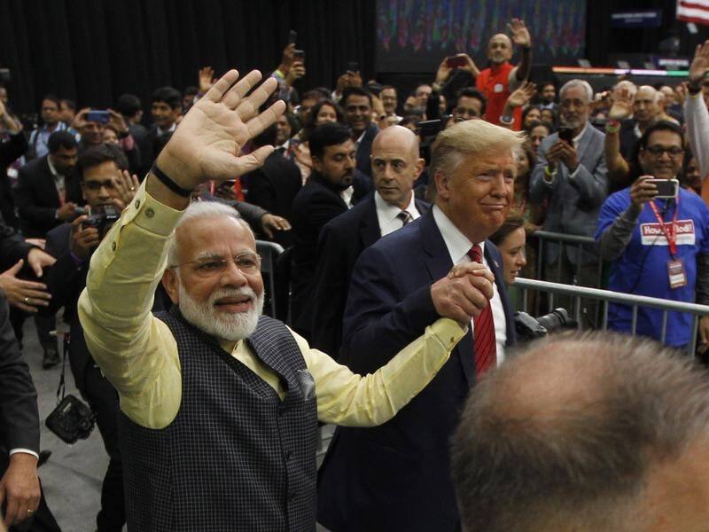 Indian Americans cheered Donald Trump in Texas as he appeared with Indian PM Narendra Modi (L).