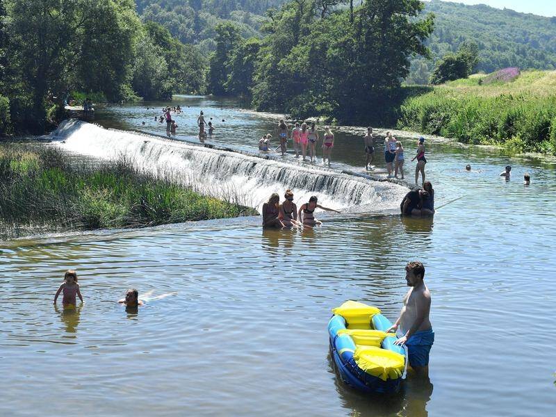 Swimmers cool off at Warleigh Weir outside Bath, England as a heatwave continues to sweep the UK.