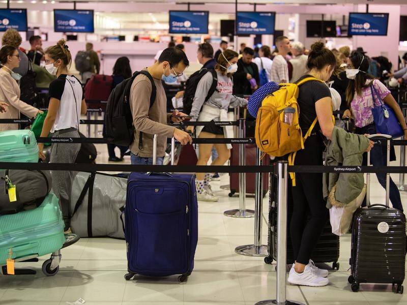 Travellers are being urged to adhere to social distancing at Sydney International Airport.