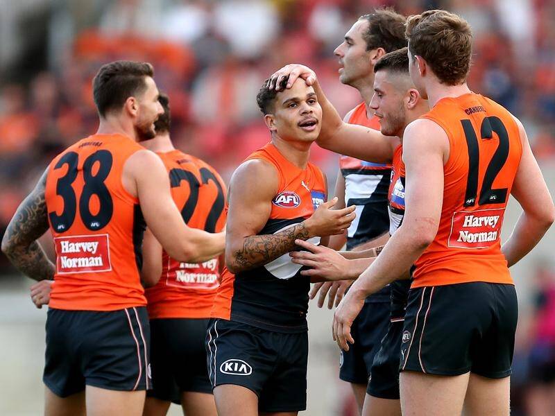 GWS players celebrate during their thrilling two-point AFL victory over Essendon.