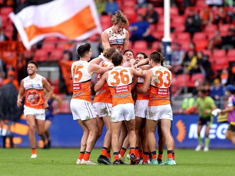 GWS players celebrate one of their 21 goals in a high-scoring win over West Coast.