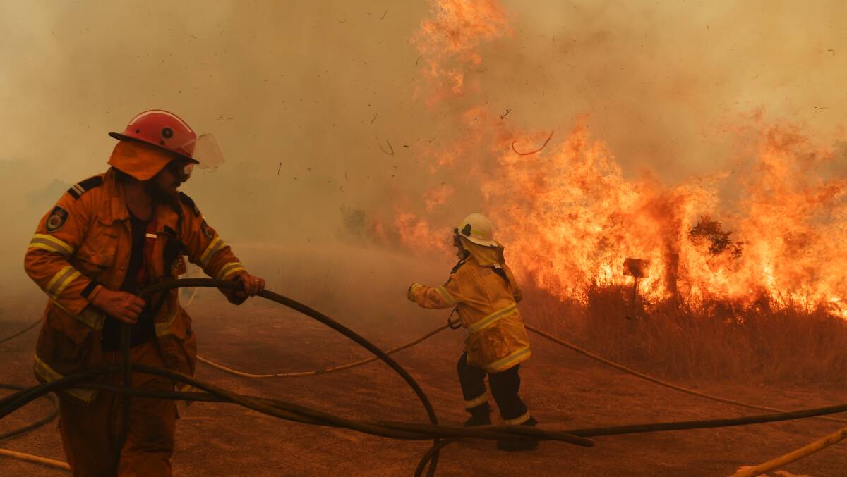Rural Fires Service firefighters battle a spot fire in Hillville, NSW on Wednesday. Picture: Getty Images